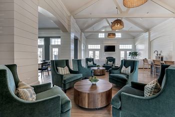 Clubhouse seating with green chairs in Indianapolis at Latitudes Apartments, Indianapolis, 46237